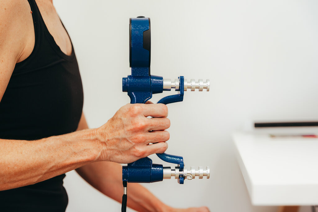 Longevity clinet performing a grip strenght test